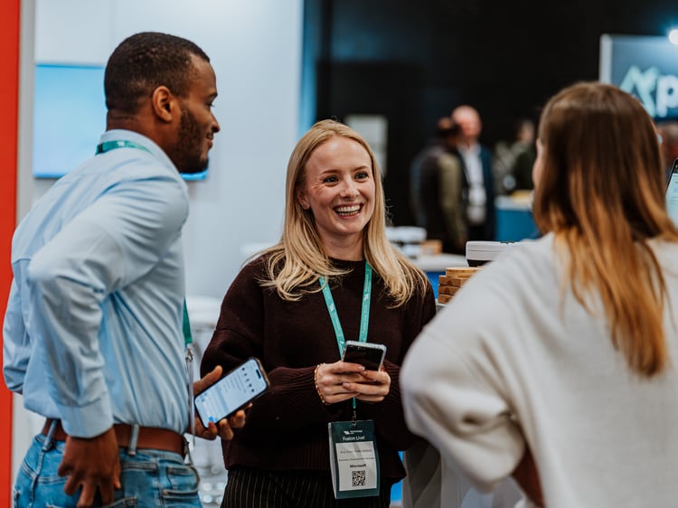 A group of people talking at an event.