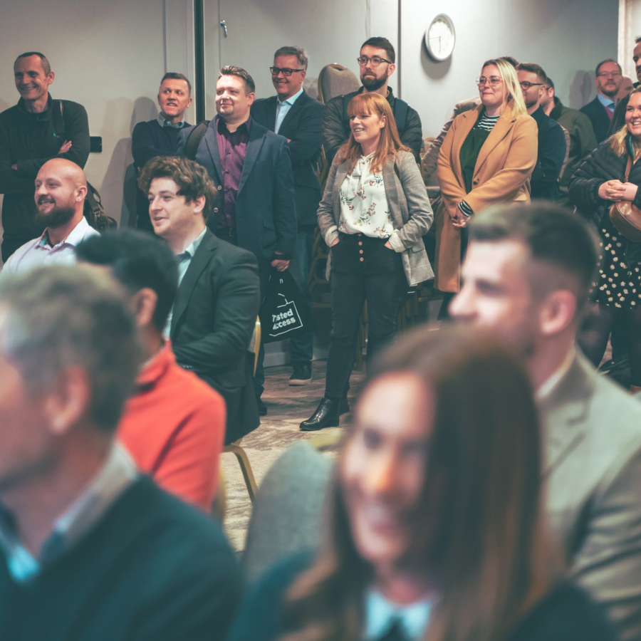 People in a crowd listening to a speaker.