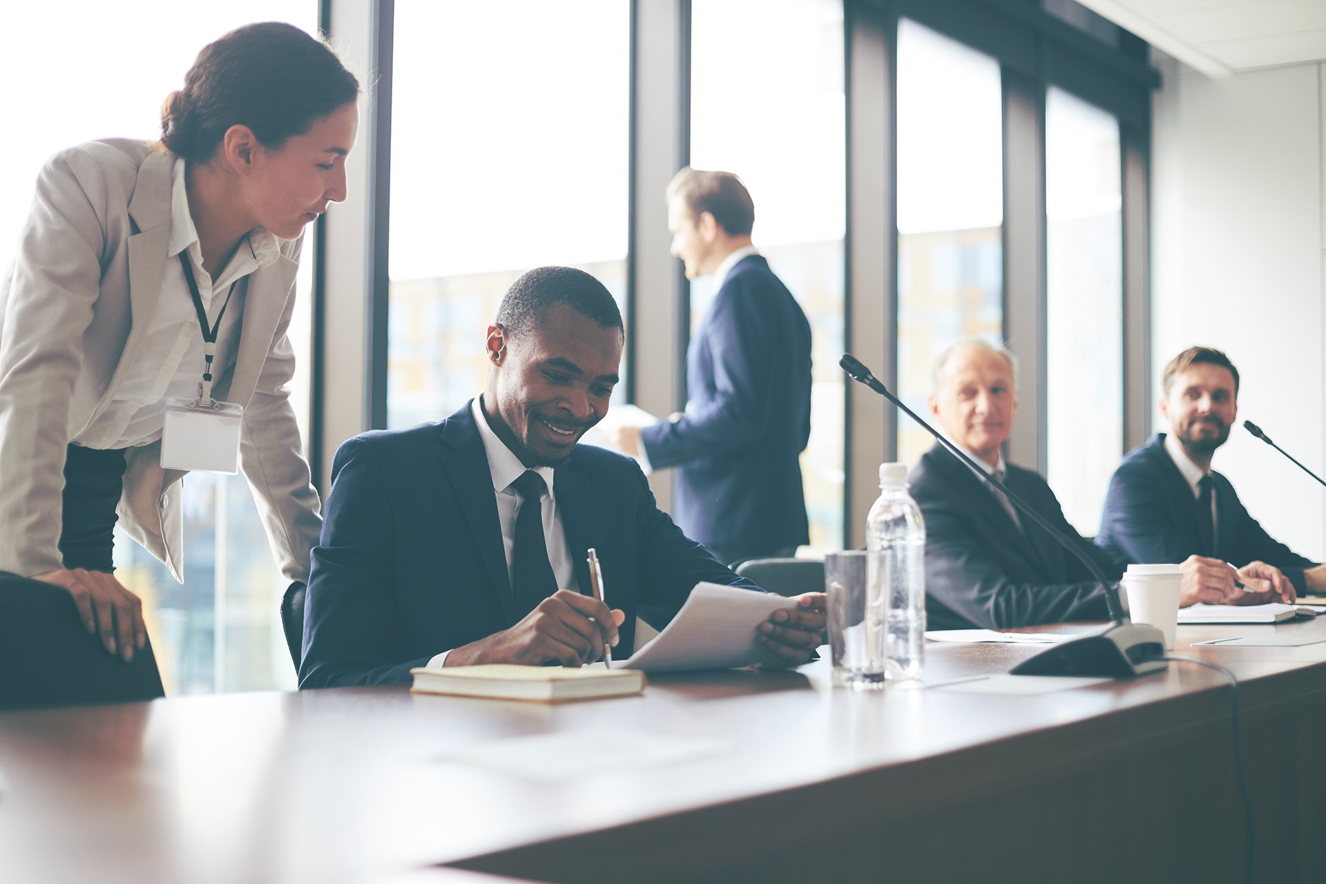 Man looking at a report during a meeting